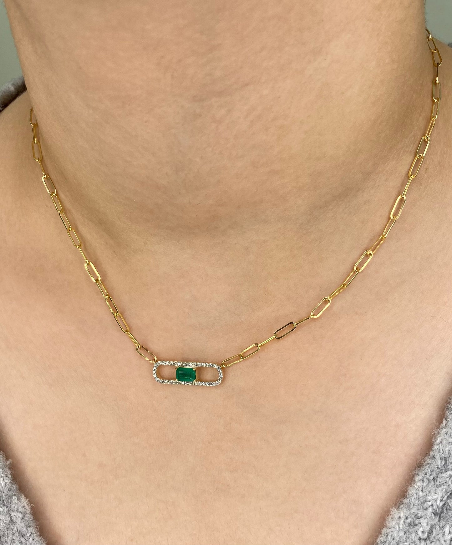 14K Solid Yellow Gold necklace with a green Emerald and diamond gemstone pendant on a white background. Trendy 14K yellow gold Paperclip necklace. 