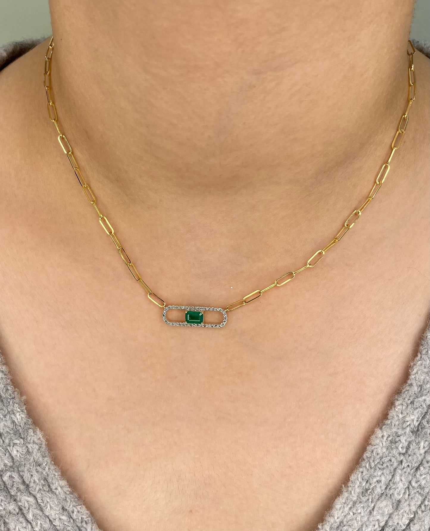 14K Solid Yellow Gold necklace with a green Emerald and diamond gemstone pendant on a white background. Trendy 14K yellow gold Paperclip necklace. 