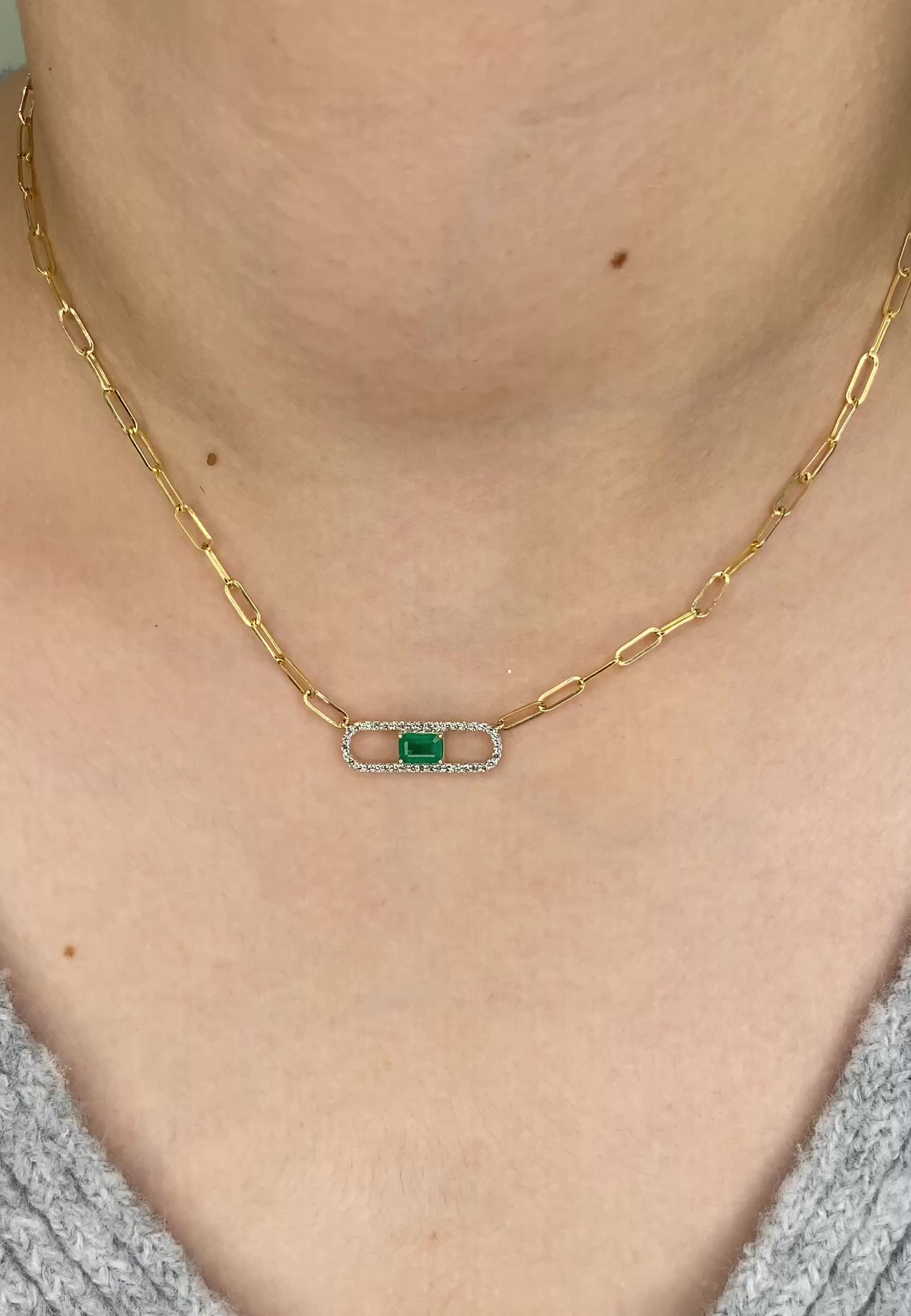 14K Solid Yellow Gold necklace with a green Emerald and diamond gemstone pendant on a white background. Trendy 14K yellow gold Paperclip necklace. 